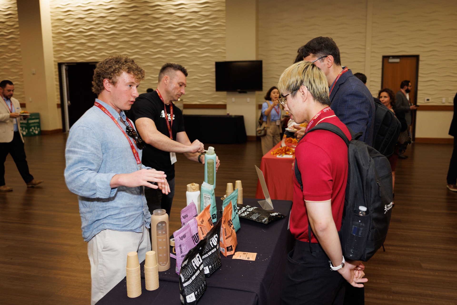 Pouring samples and talking with attendees at a USC Marshall event