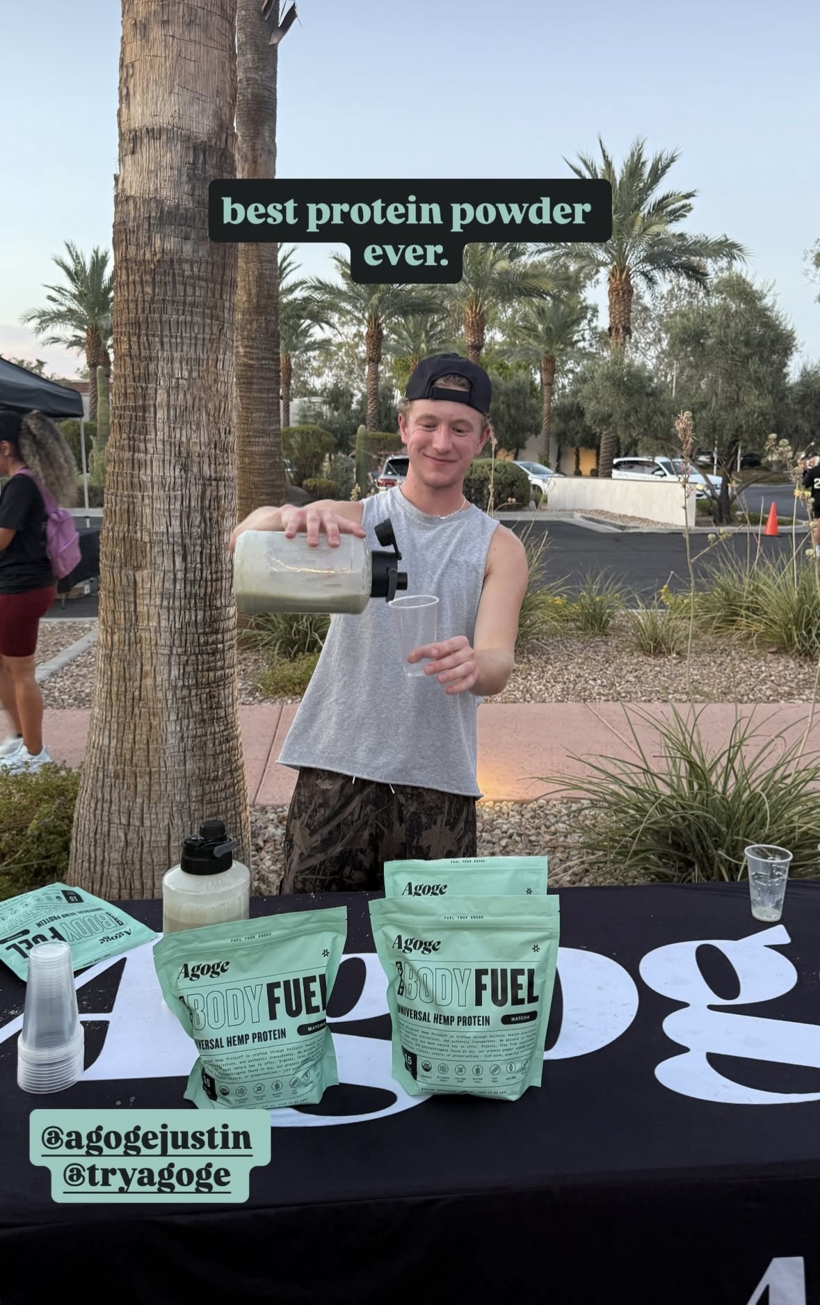 Pouring a protein sample at an outdoor Agoge sampling table